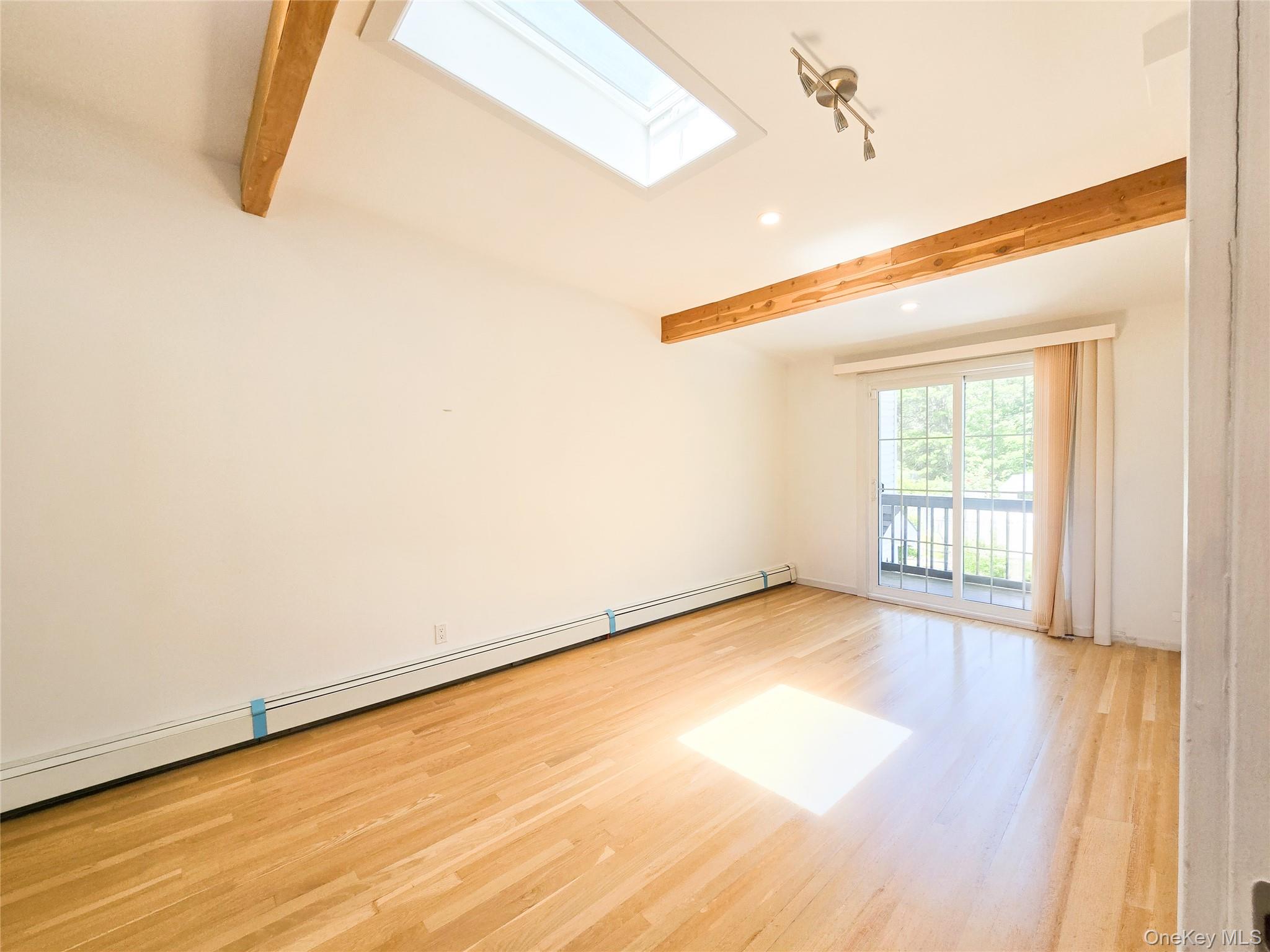 249 Cold Spring Road Syosset, NY 11791 - Photo 14 of 28 a view of an empty room with wooden floor and a window