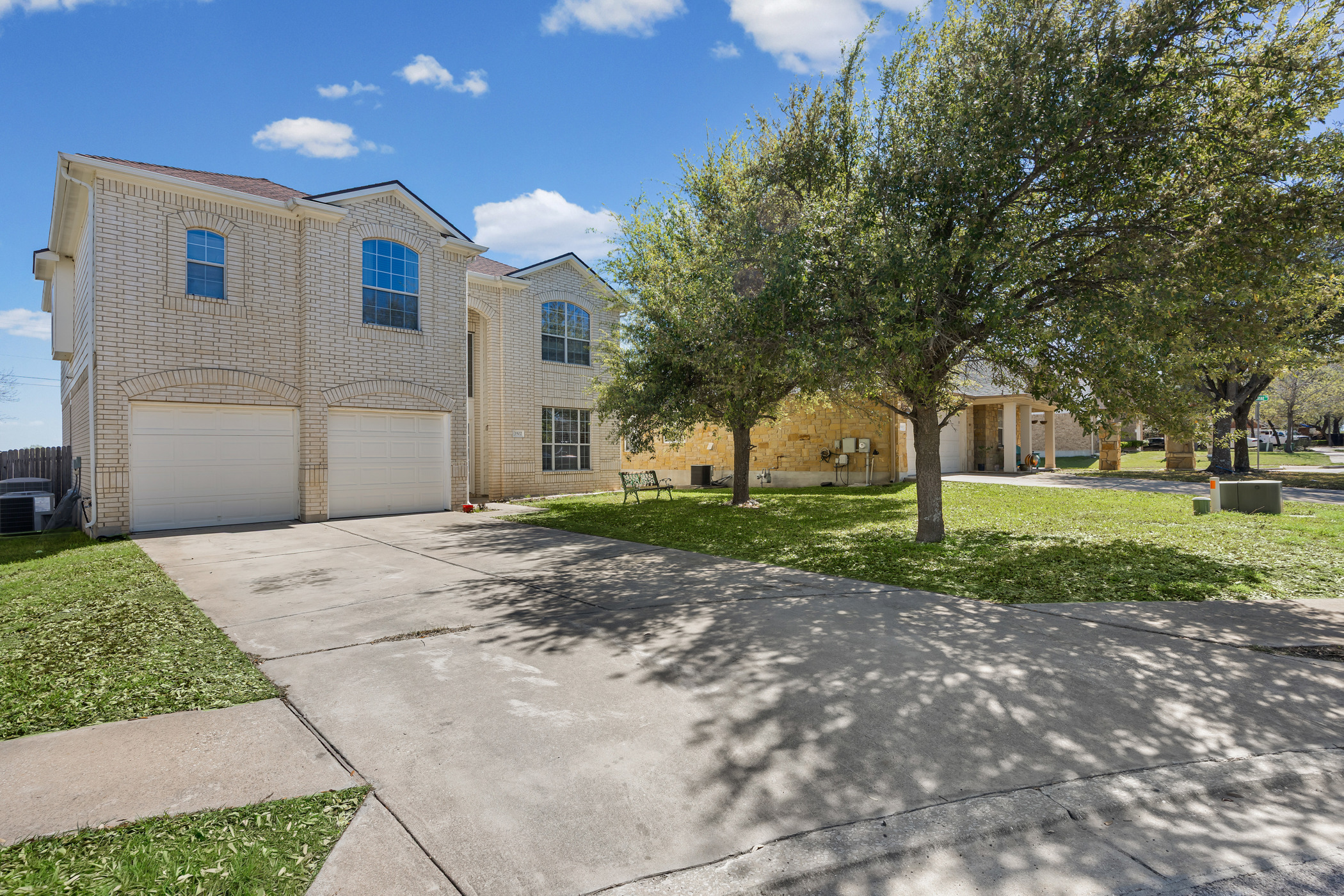 3502 Shiraz Loop Round Rock, TX 78665 - Photo 1 of 23 View of front of house featuring a front lawn, driveway, a garage, and brick siding