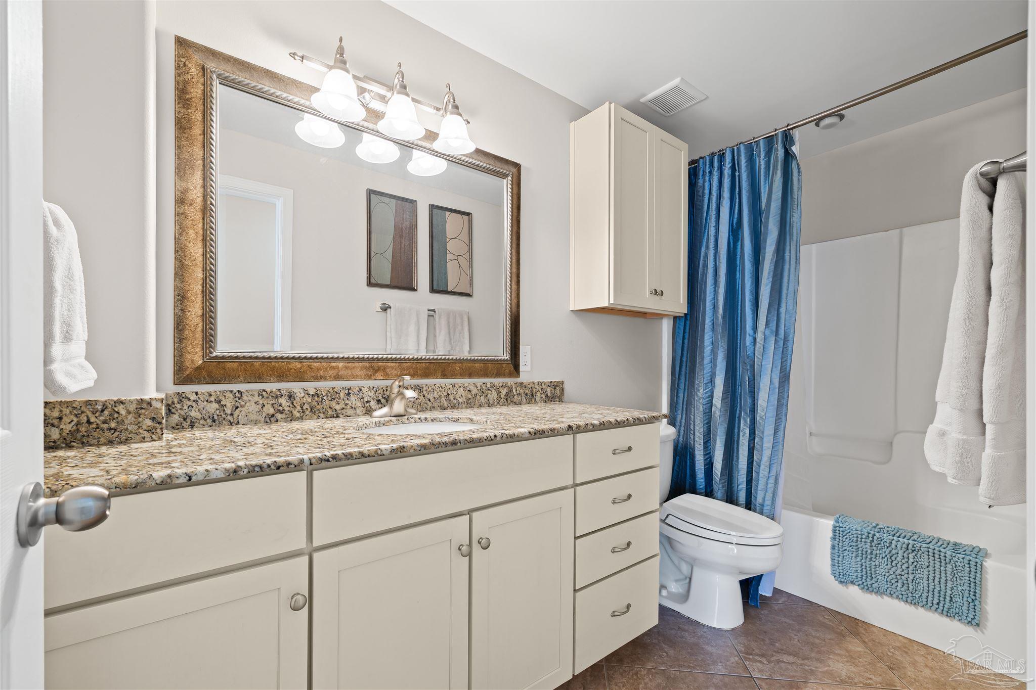 1299 Fort Pickens Road, Unit 10 Pensacola Beach, FL 32561 - Photo 19 of 58 a bathroom with a toilet sink and mirror