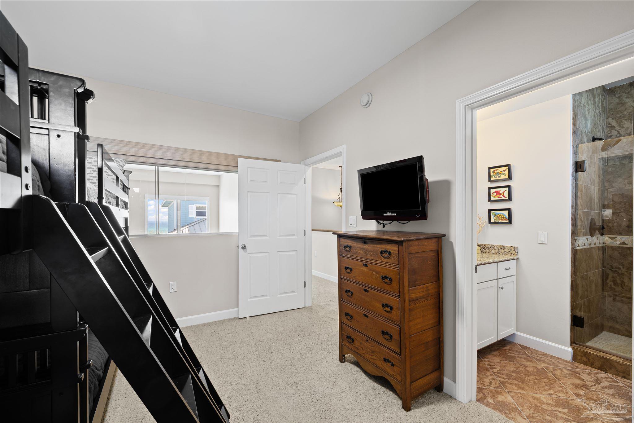 1299 Fort Pickens Road, Unit 10 Pensacola Beach, FL 32561 - Photo 26 of 58 a view of bedroom with flat screen tv