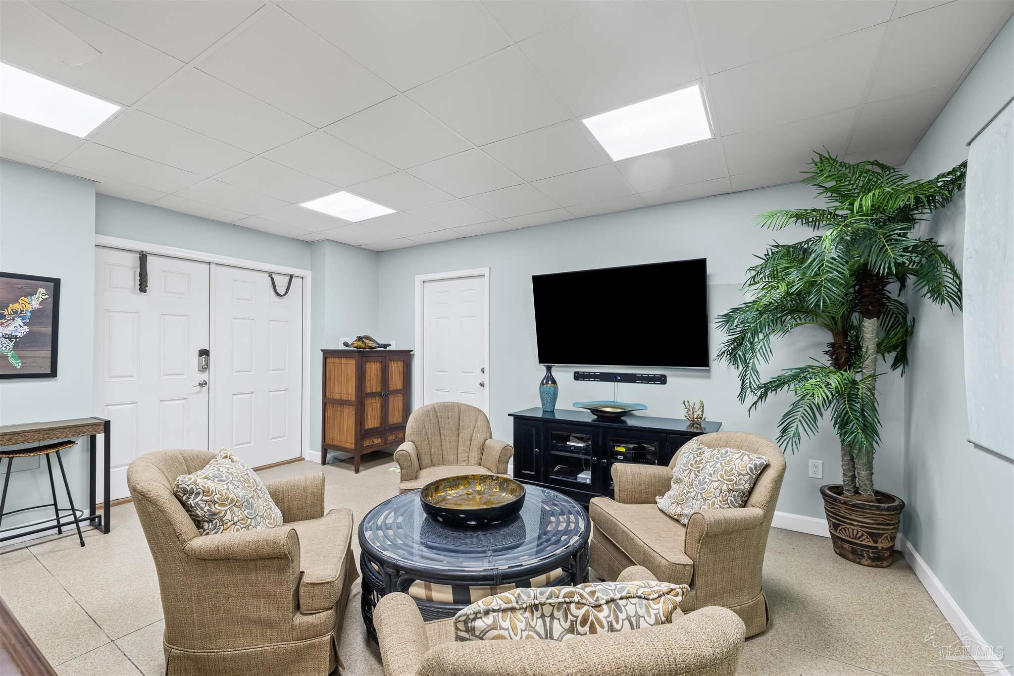 1299 Fort Pickens Road, Unit 10 Pensacola Beach, FL 32561 - Photo 28 of 58 a living room with furniture and a flat screen tv