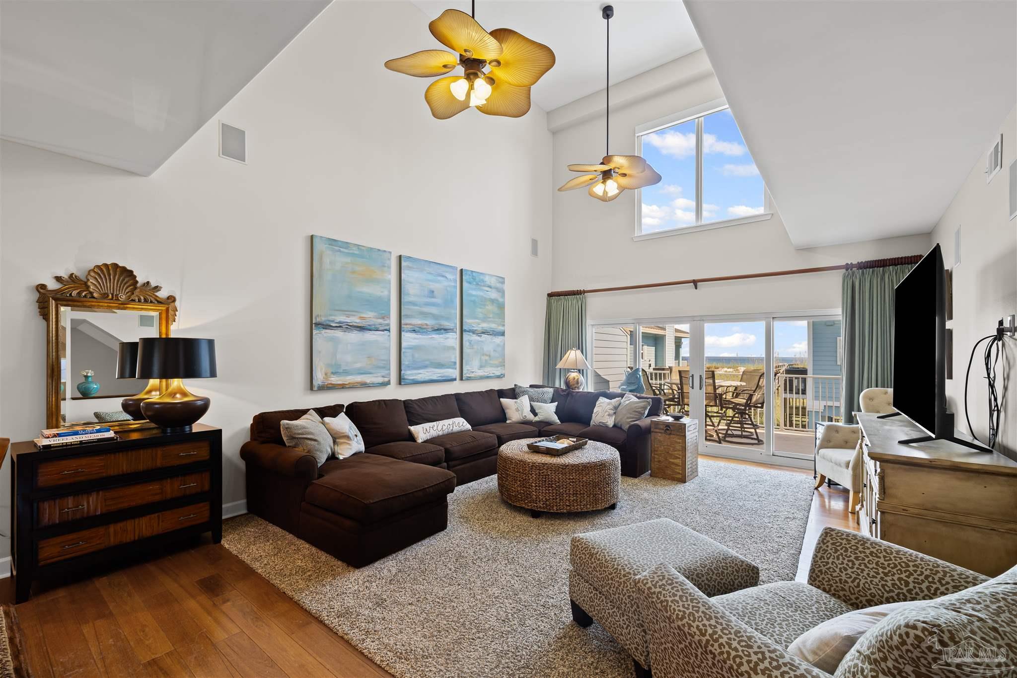 1299 Fort Pickens Road, Unit 10 Pensacola Beach, FL 32561 - Photo 4 of 58 a living room with furniture and a flat screen tv