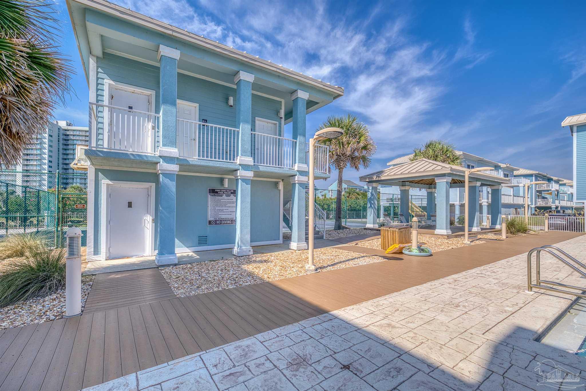 1299 Fort Pickens Road, Unit 10 Pensacola Beach, FL 32561 - Photo 43 of 58 a view of a house with a porch and furniture