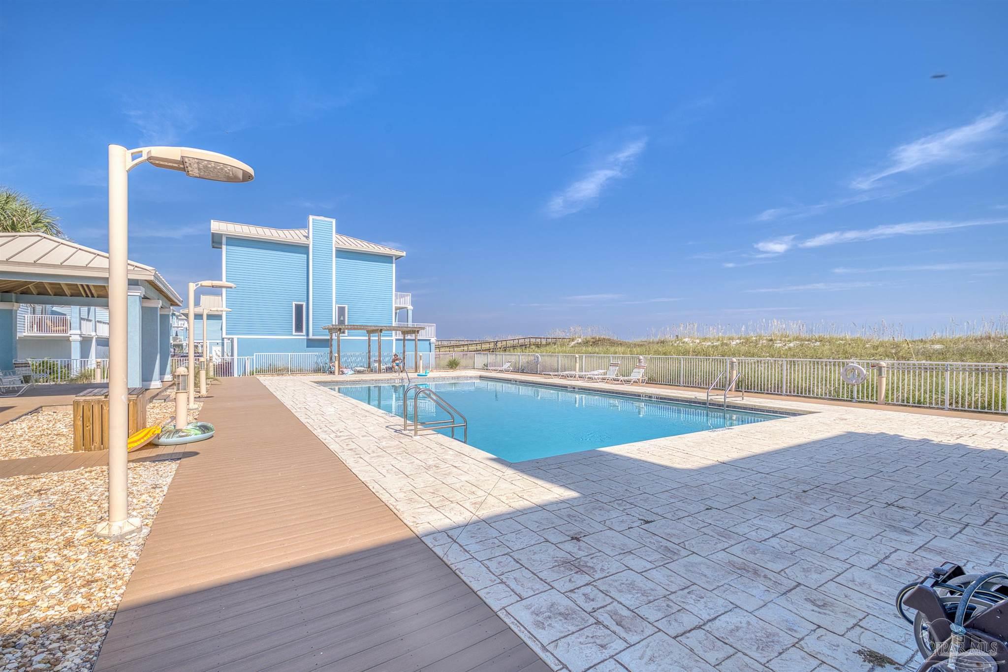 1299 Fort Pickens Road, Unit 10 Pensacola Beach, FL 32561 - Photo 45 of 58 a view of a swimming pool and an ocean
