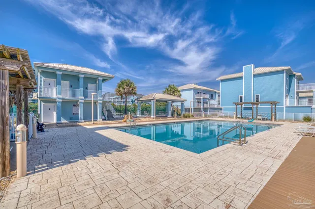 an aerial view of residential house with outdoor space and ocean view