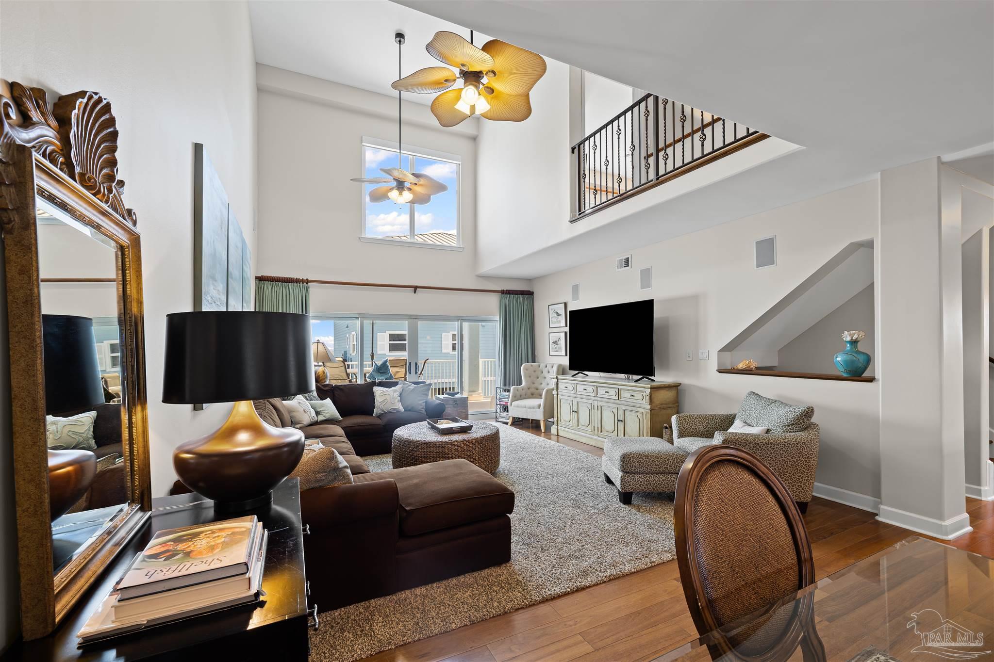 1299 Fort Pickens Road, Unit 10 Pensacola Beach, FL 32561 - Photo 5 of 58 a living room with furniture and a flat screen tv