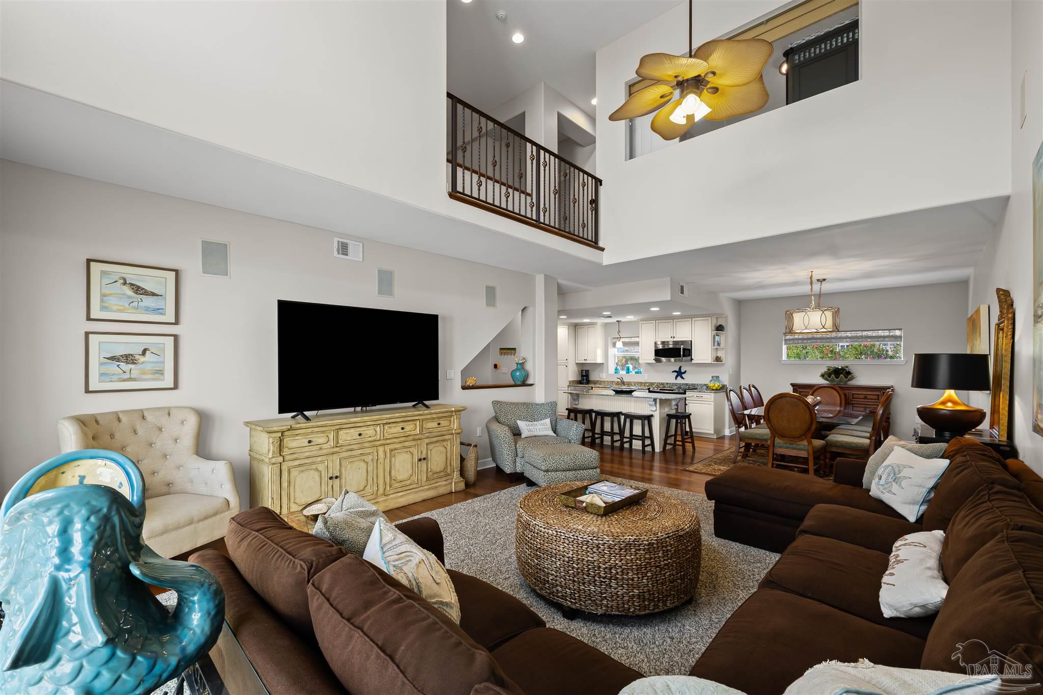 1299 Fort Pickens Road, Unit 10 Pensacola Beach, FL 32561 - Photo 6 of 58 a living room with furniture and a flat screen tv