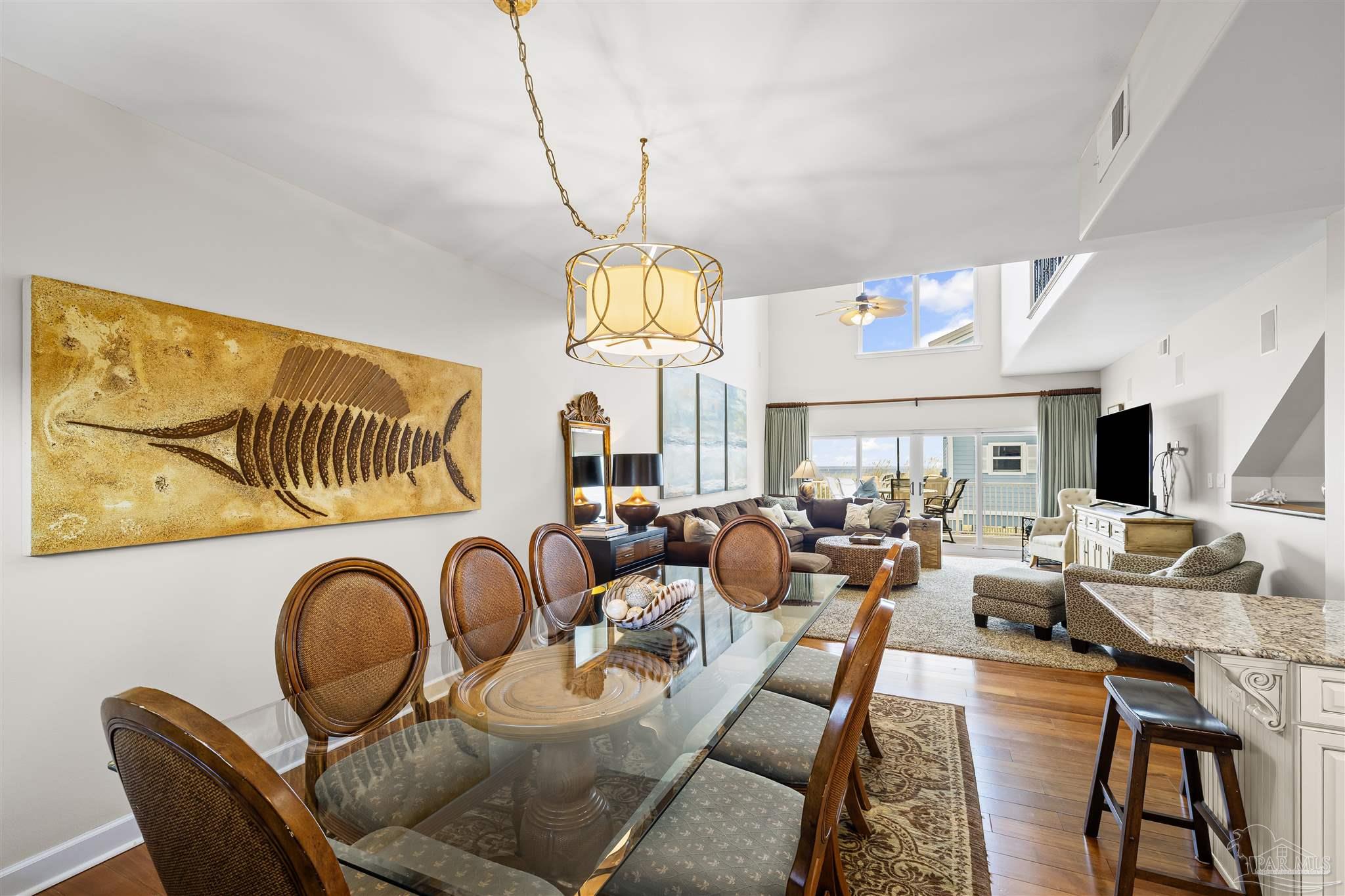 1299 Fort Pickens Road, Unit 10 Pensacola Beach, FL 32561 - Photo 7 of 58 a living room with lots of furniture and a chandelier