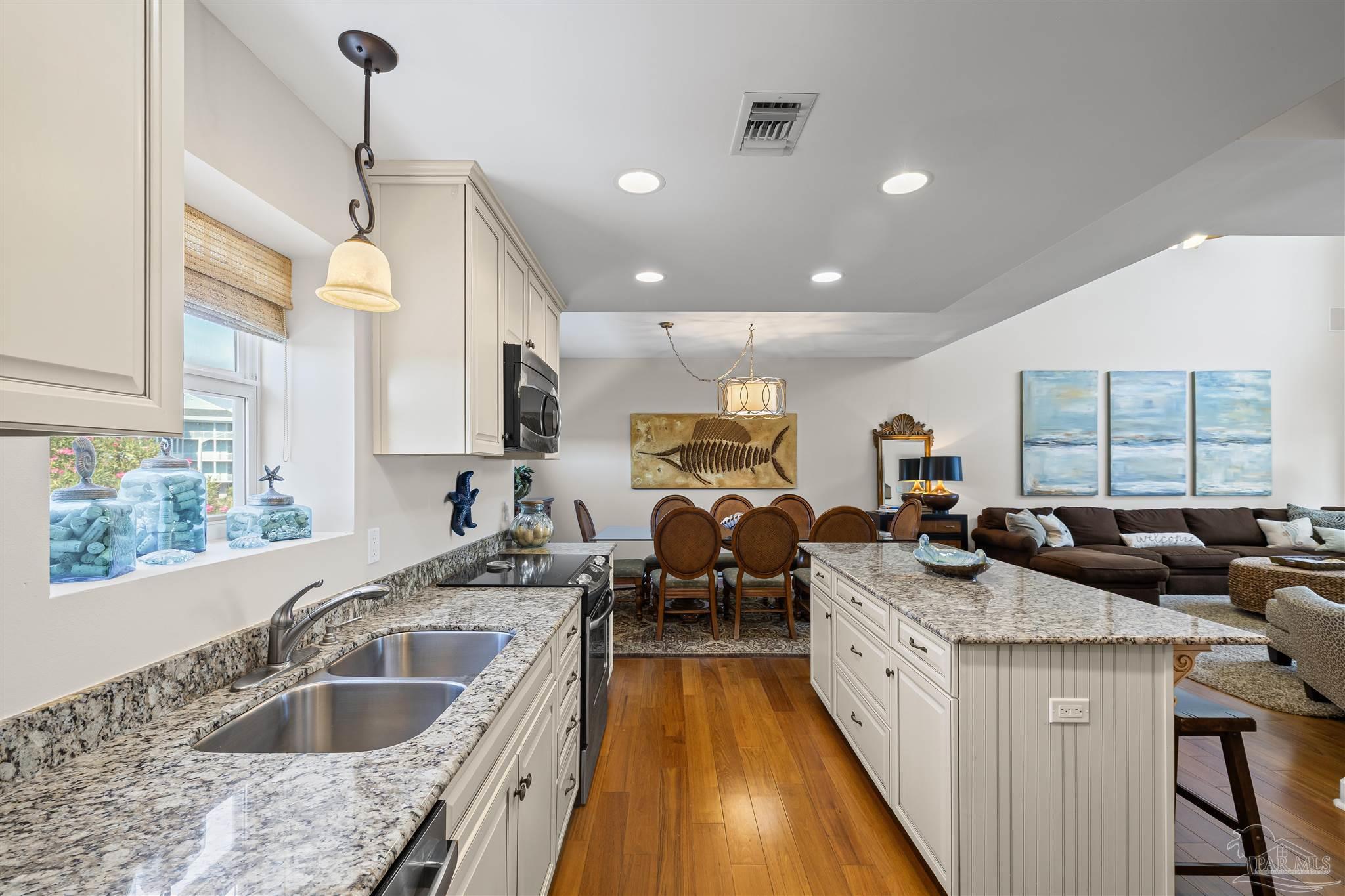 1299 Fort Pickens Road, Unit 10 Pensacola Beach, FL 32561 - Photo 8 of 58 a kitchen with sink stove and cabinets