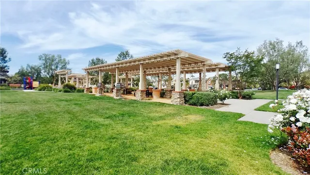 a view of a house with a big yard and large trees