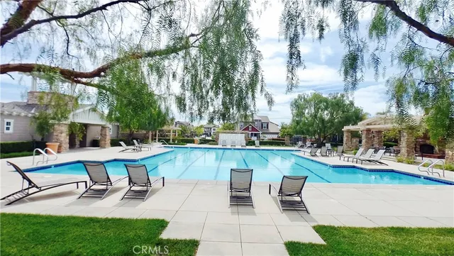 a view of a swimming pool with chairs in patio