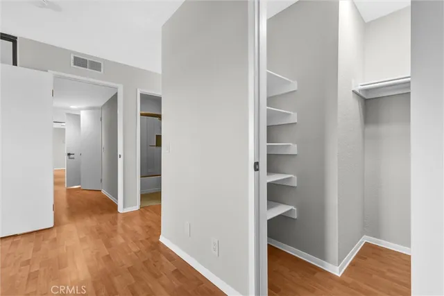 a view of a room with wooden floor