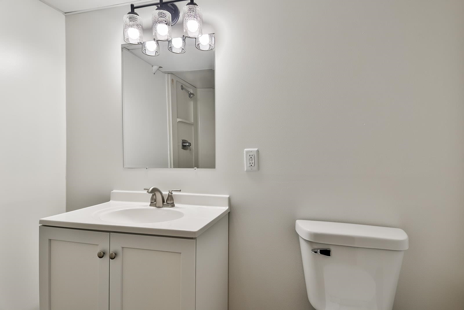 8567 Valley View Drive Stillman Valley, IL 61084 - Photo 11 of 36 a bathroom with a sink a toilet and a mirror