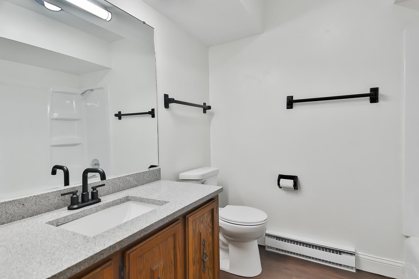 8567 Valley View Drive Stillman Valley, IL 61084 - Photo 27 of 36 a bathroom with a granite countertop sink a toilet and a mirror