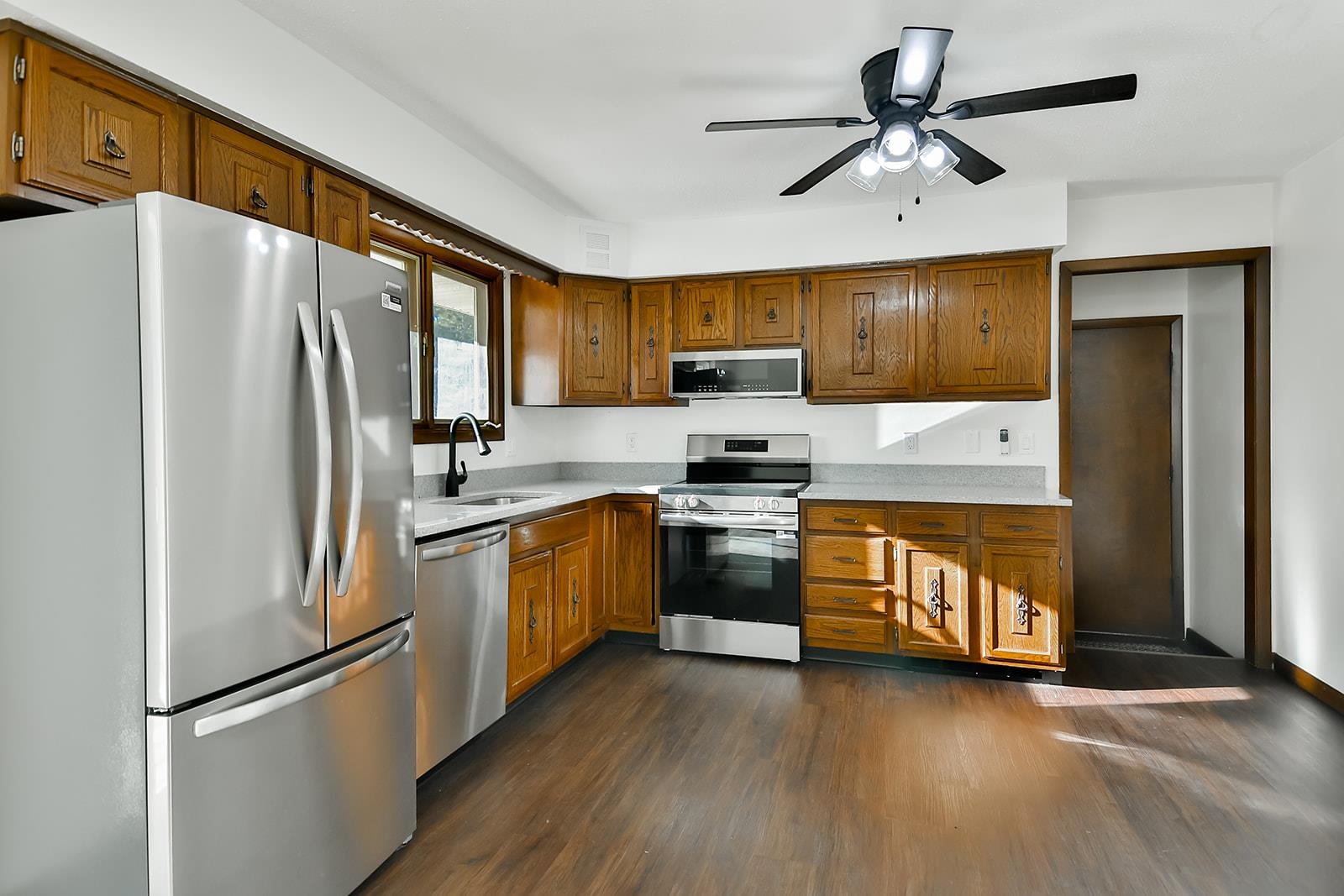 8567 Valley View Drive Stillman Valley, IL 61084 - Photo 35 of 36 a kitchen with stainless steel appliances granite countertop a refrigerator a stove a sink dishwasher and a refrigerator with wooden floor