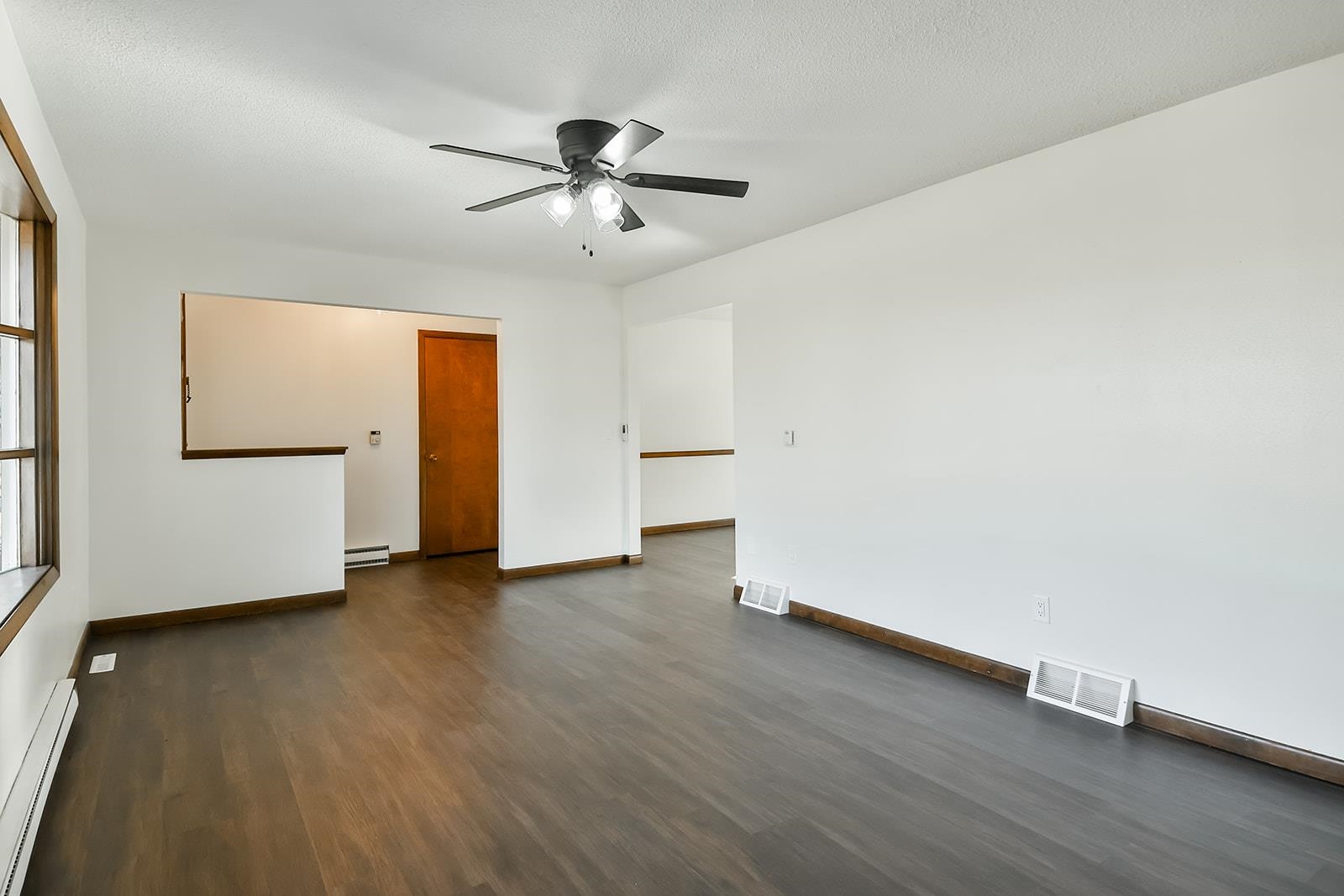 8567 Valley View Drive Stillman Valley, IL 61084 - Photo 5 of 36 an empty room with wooden floor cabinet and windows