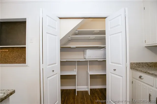 a view of walk in closet with empty racks