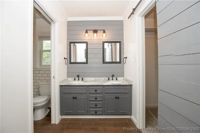 a bathroom with a toilet a sink and mirror