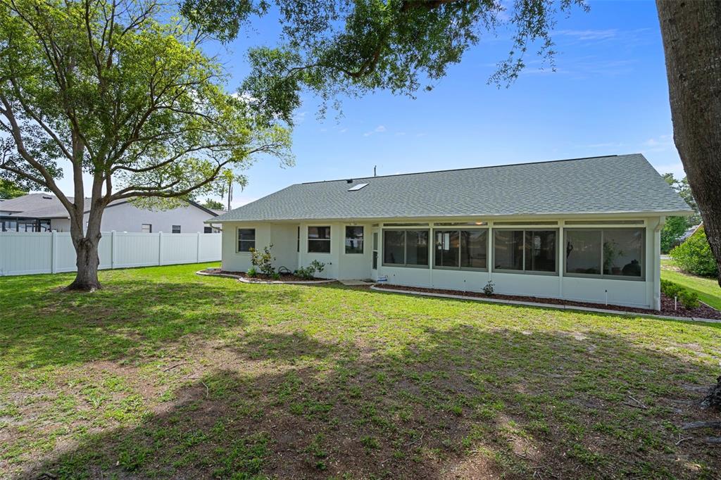 5035 Harbinger Road Spring Hill, FL 34608 - Photo 45 of 47 a front view of a house with a garden