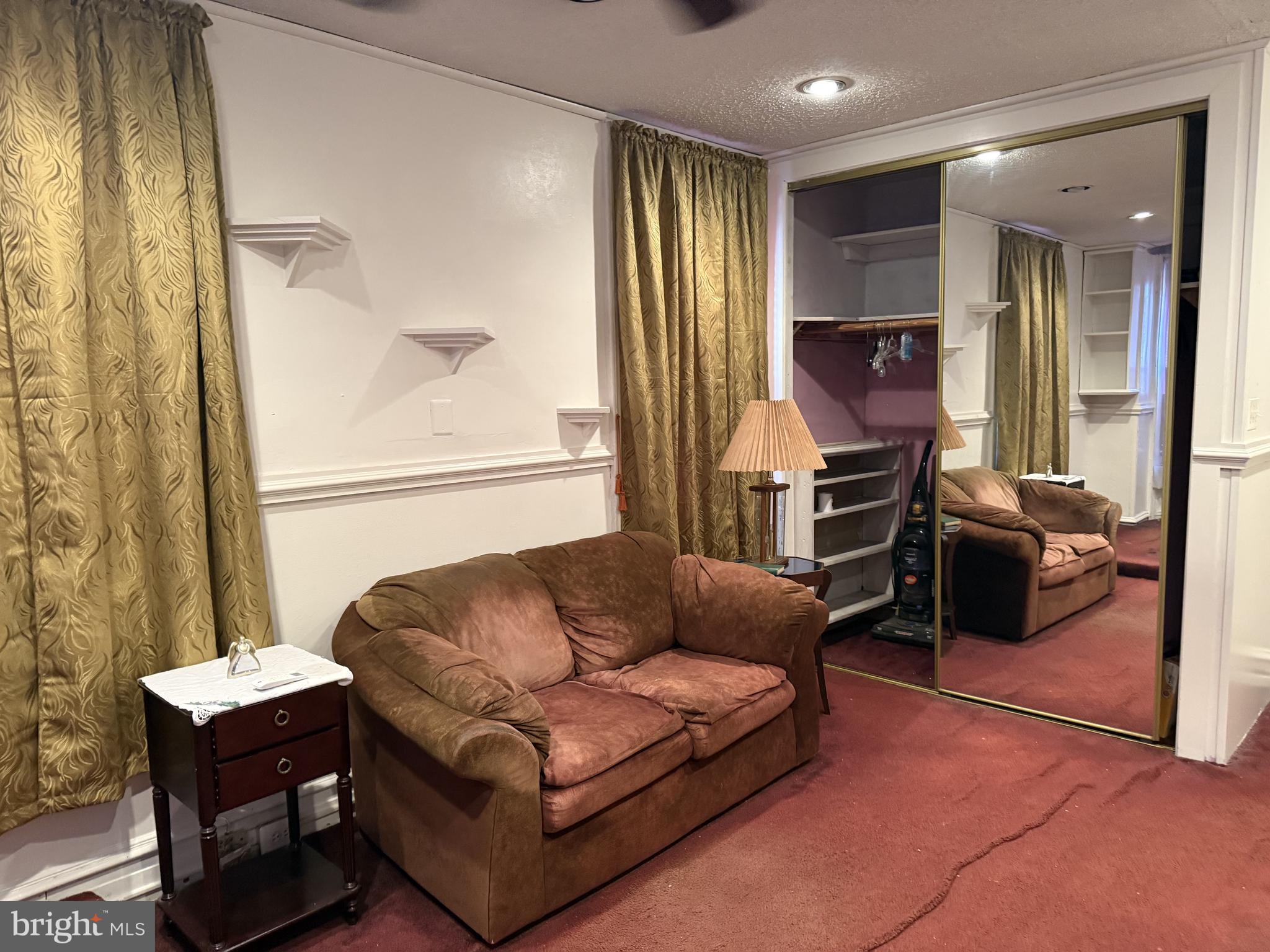 2136 North 21st Street Philadelphia, PA 19121 - Photo 14 of 17 a living room with furniture a flat screen tv and a window
