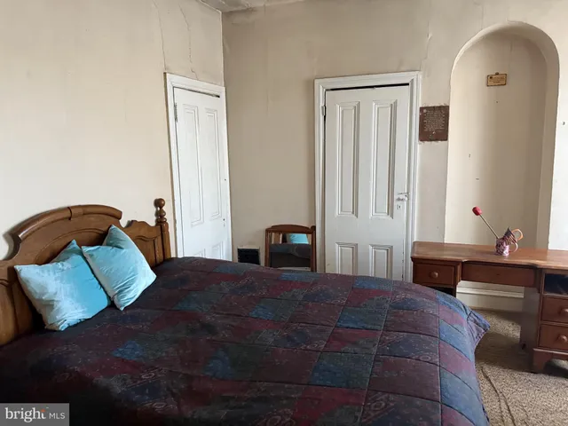 a bedroom with a bed and with furniture