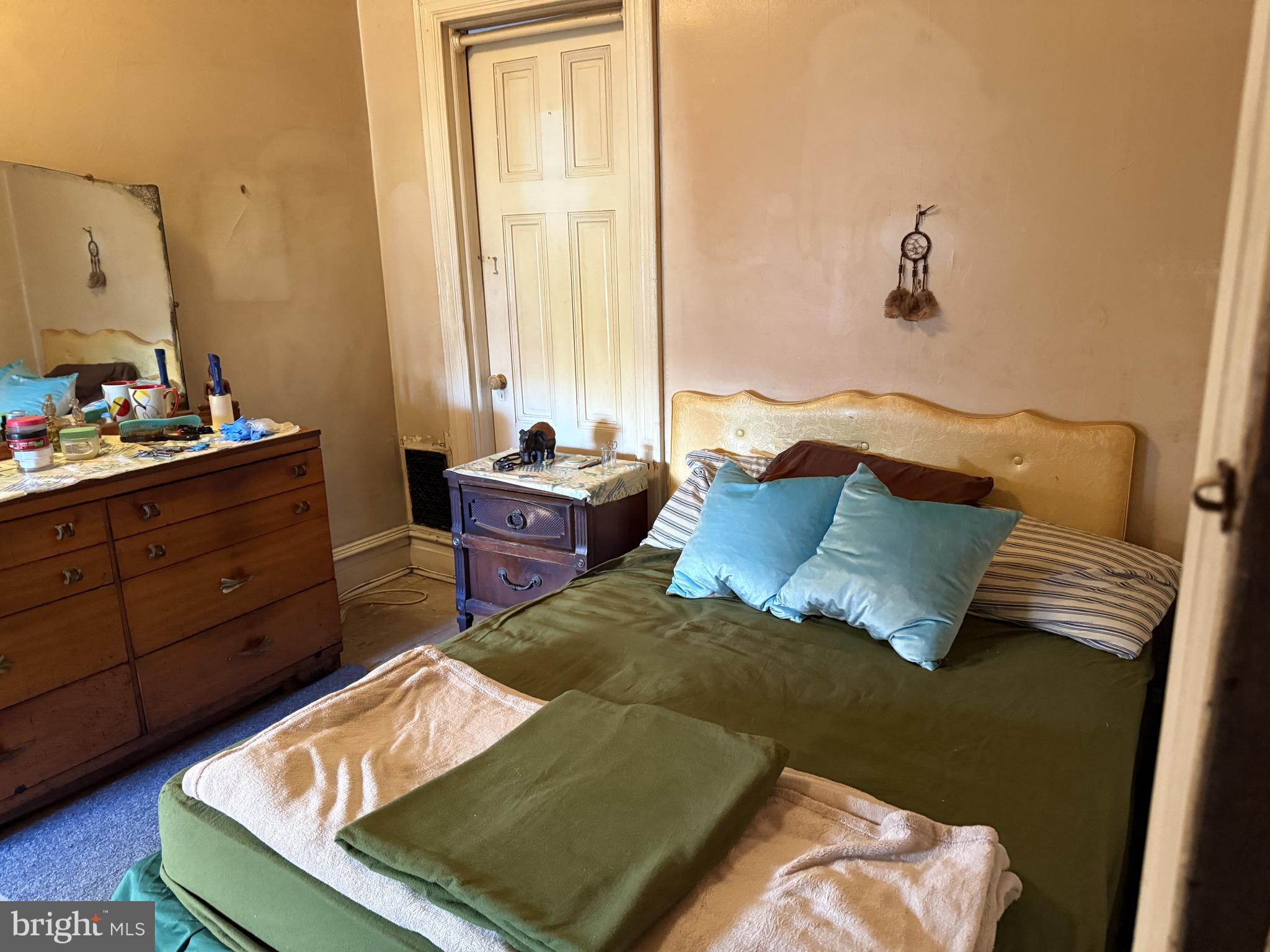 2136 North 21st Street Philadelphia, PA 19121 - Photo 10 of 17 a bed sitting in a bedroom next to a window