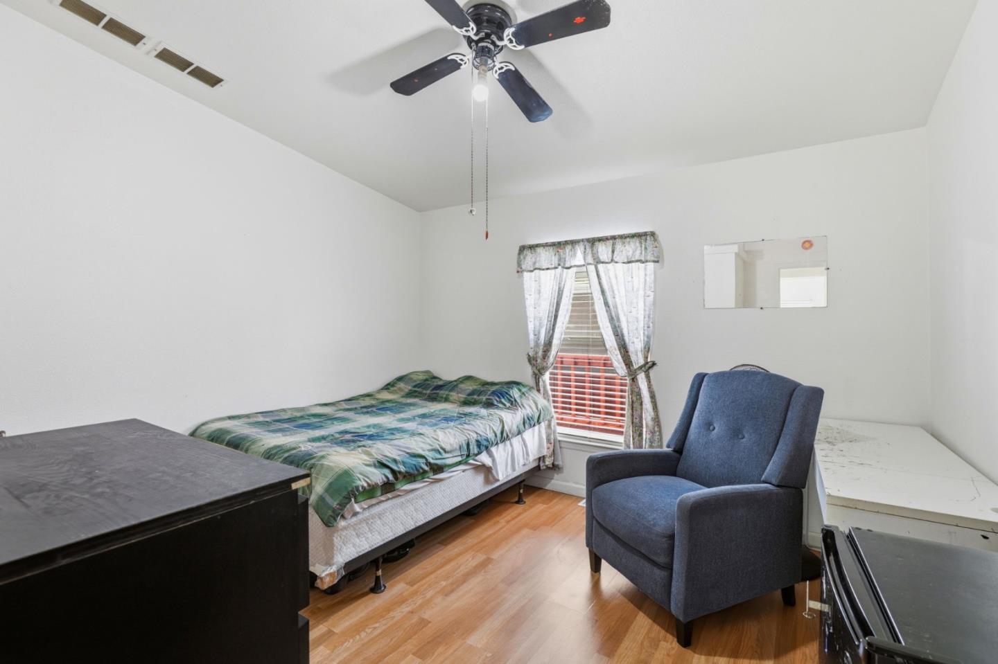 500 West 10th Street, Unit 119 Gilroy, CA 95020 - Photo 12 of 27 a bedroom with furniture and a window
