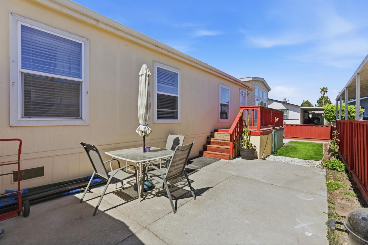 500 West 10th Street, Unit 119 Gilroy, CA 95020 - Photo 21 of 27 a backyard of a house with barbeque oven table and chairs