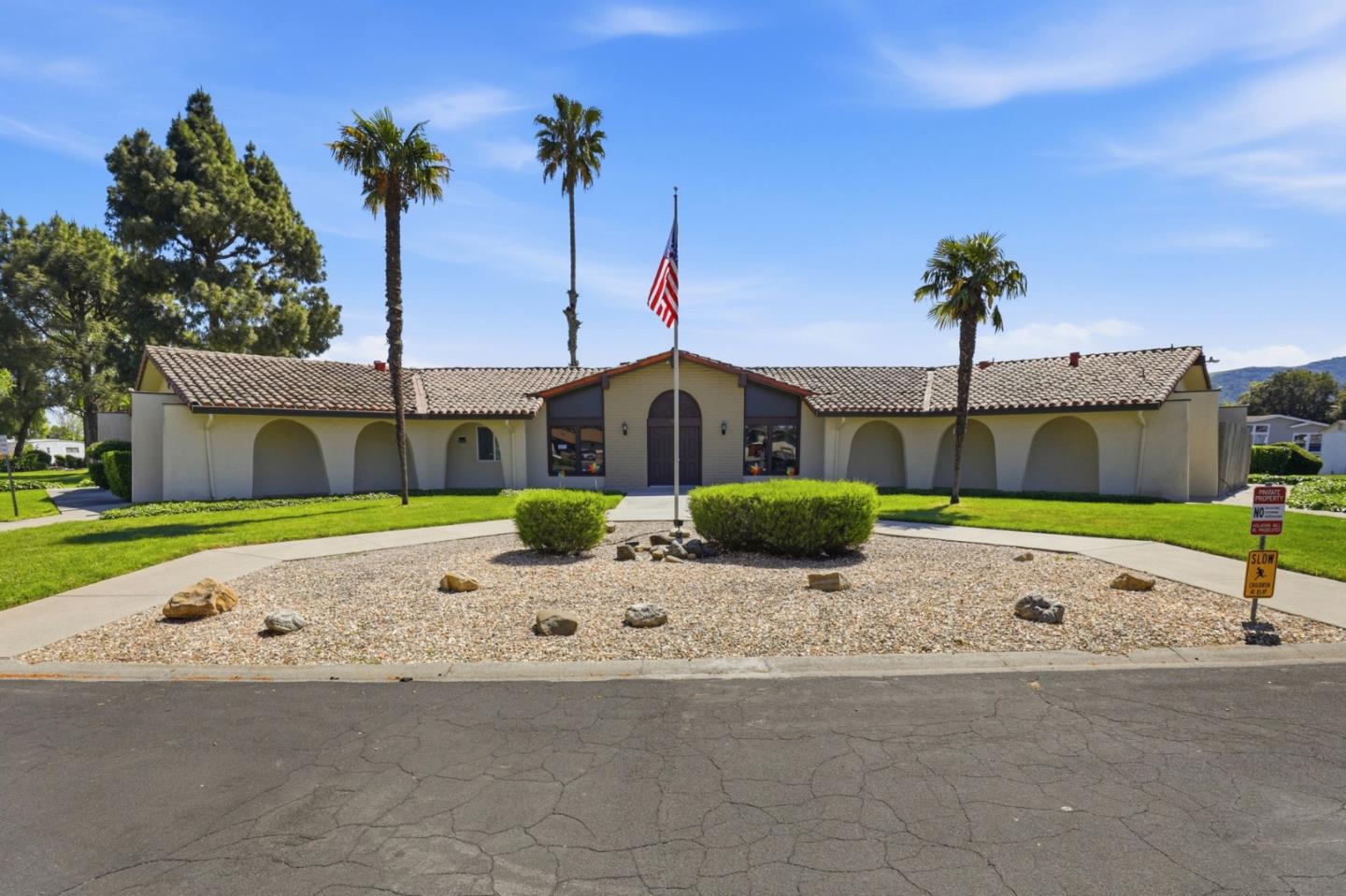 500 West 10th Street, Unit 119 Gilroy, CA 95020 - Photo 26 of 27 a front view of a house with a yard and garage