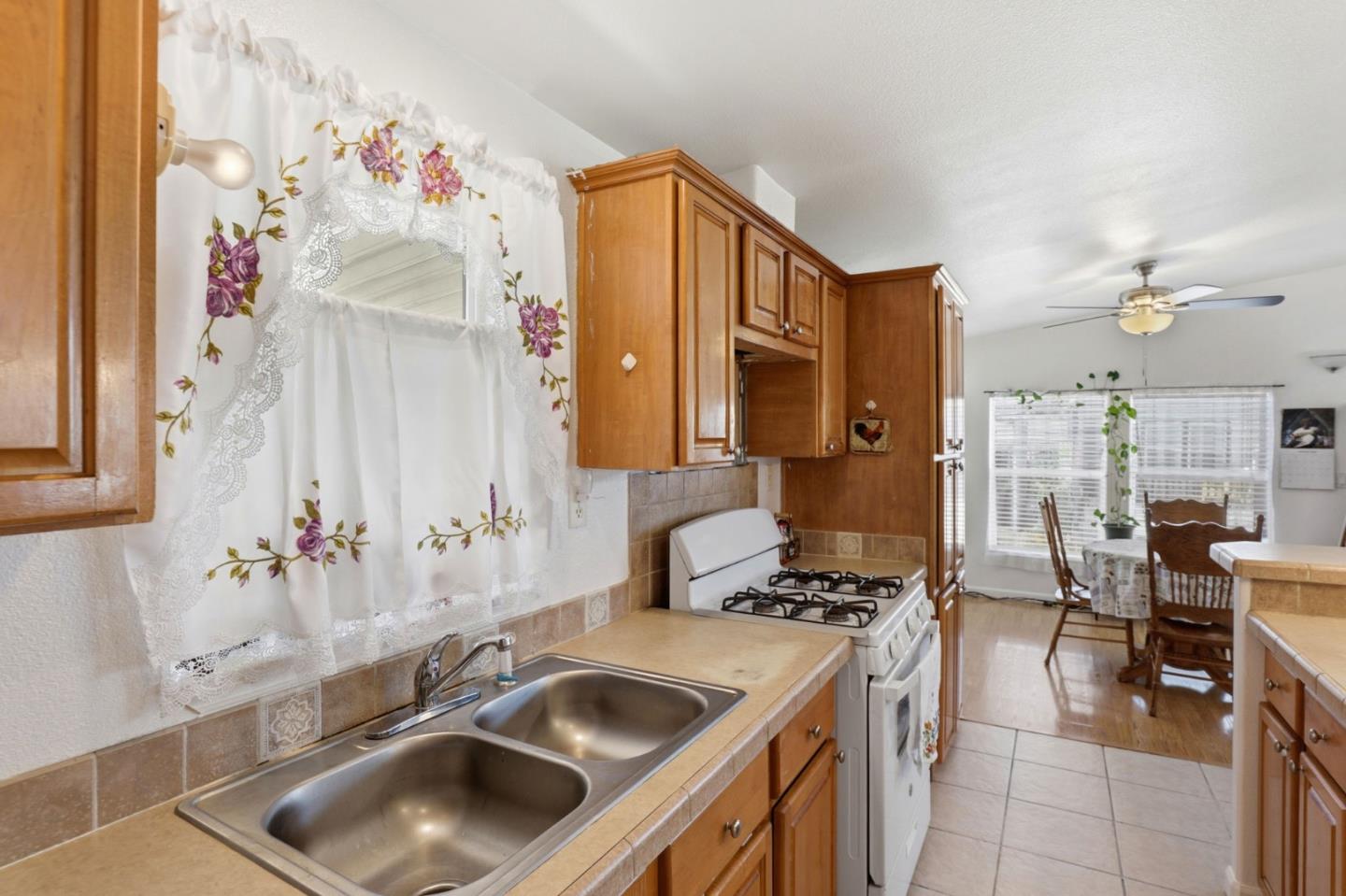 500 West 10th Street, Unit 119 Gilroy, CA 95020 - Photo 6 of 27 a kitchen with stainless steel appliances a sink and a refrigerator