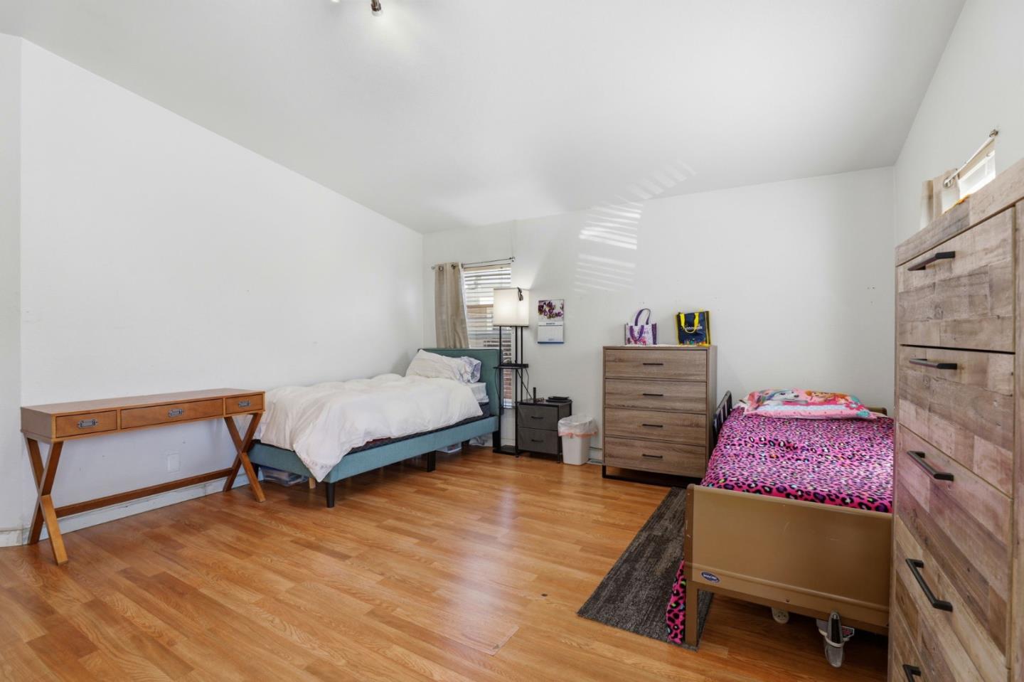 500 West 10th Street, Unit 119 Gilroy, CA 95020 - Photo 10 of 27 a bedroom with furniture and a wooden floor