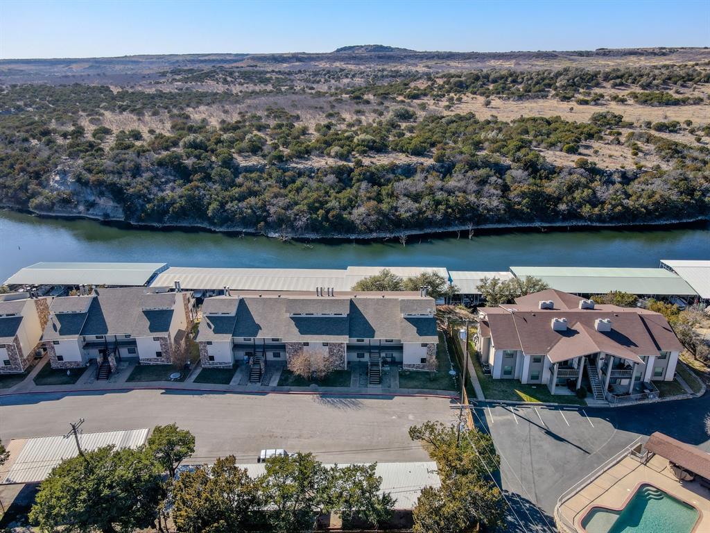 3037 Hells Gate Loop, Unit C208 Strawn, TX 76475 - Photo 23 of 24 an aerial view of a house with a lake view