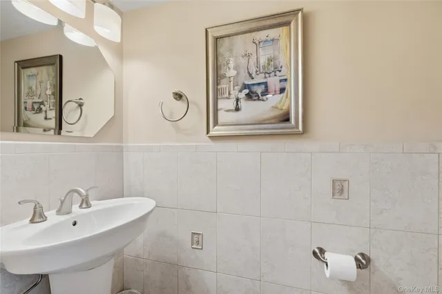 a bathroom with a sink and mirror with toilet