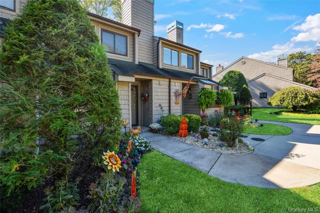 a view of a chair and table in backyard of the house