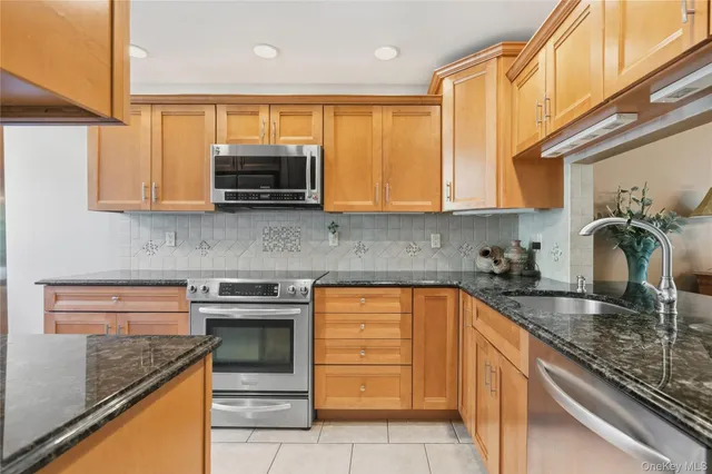a kitchen with granite countertop a sink and cabinets