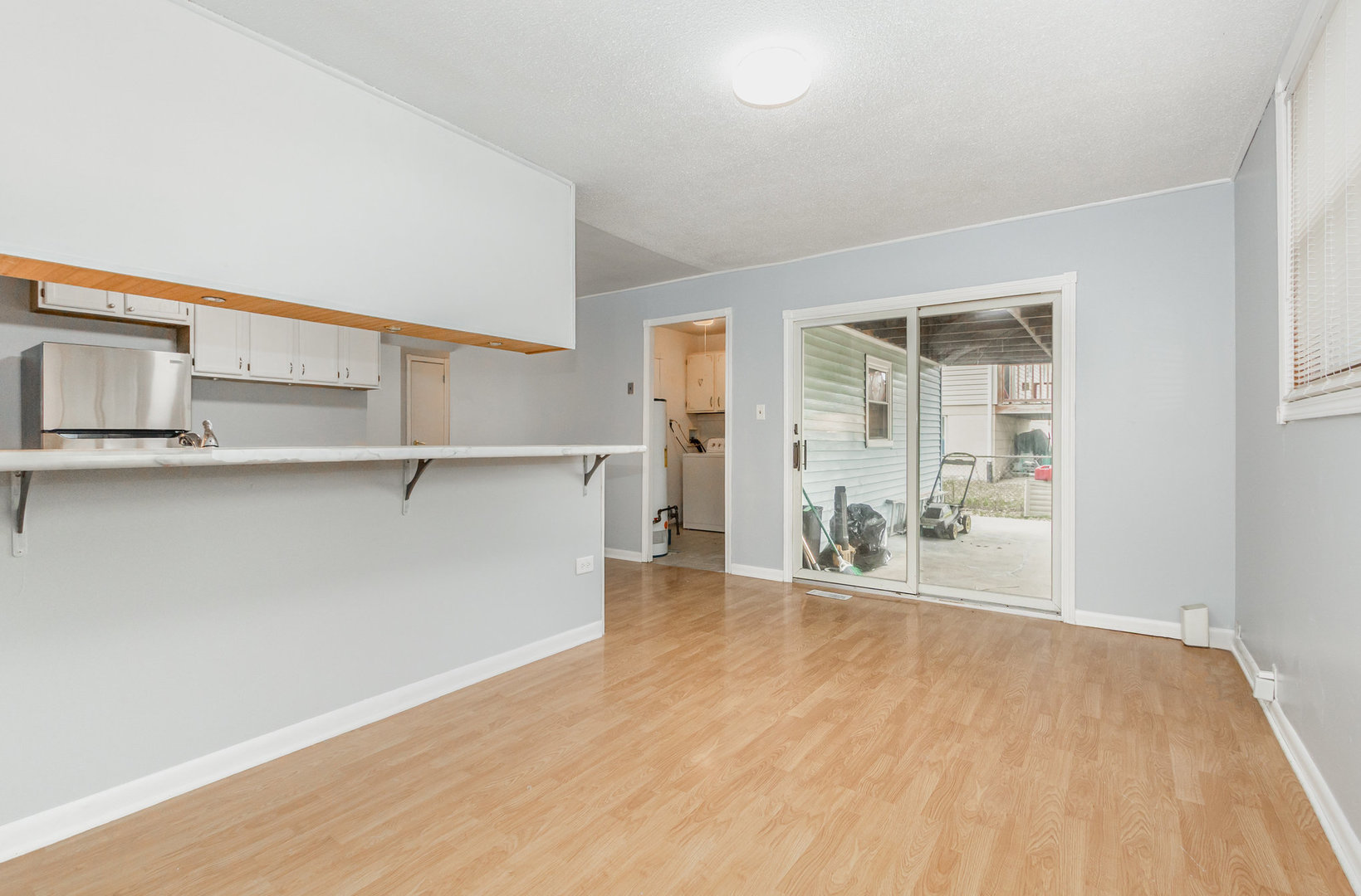 720 Union Avenue Romeoville, IL 60446 - Photo 5 of 15 an empty room with wooden floor and windows
