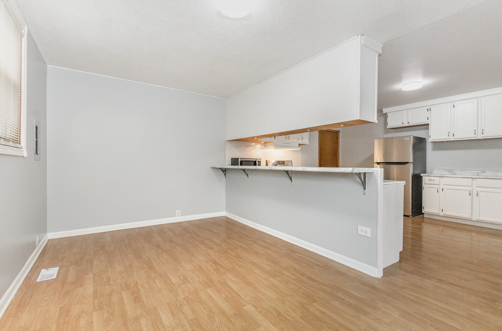 720 Union Avenue Romeoville, IL 60446 - Photo 6 of 15 a view of a kitchen with wooden floor and electronic appliances