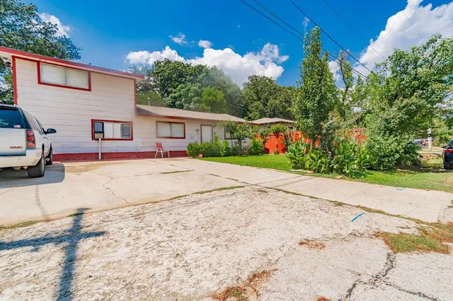a view of garage with deck and trees