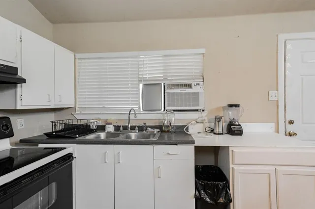 a kitchen with a sink and cabinets