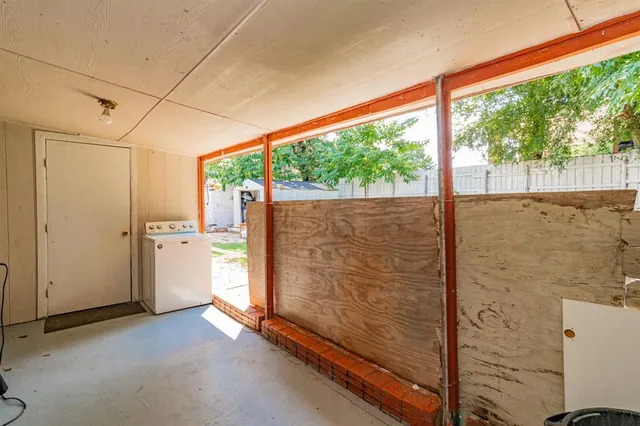 a view of a balcony with refrigerator