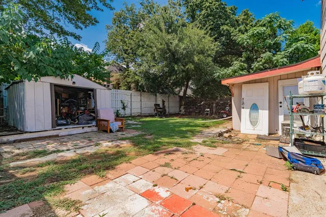 a view of a backyard with a large tree