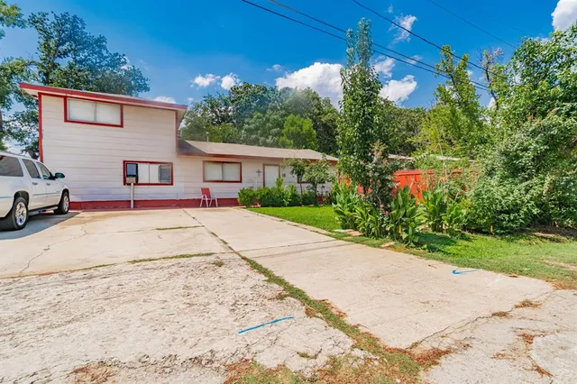 a view of backyard of house with green space
