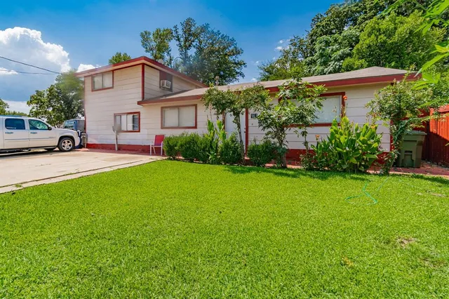 a front view of a house with a yard and porch