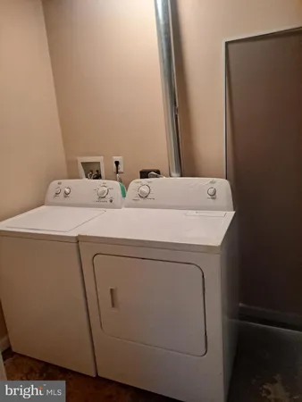 a living room with a fireplace and a potted plant