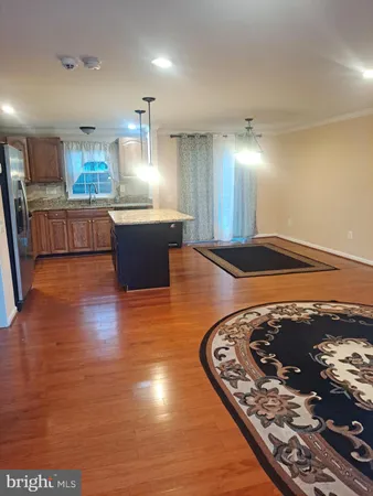 a kitchen with stainless steel appliances granite countertop a stove and a refrigerator