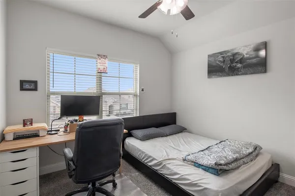 a bedroom with a bed and a desk