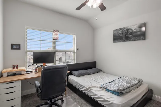 a bedroom with a bed and a desk