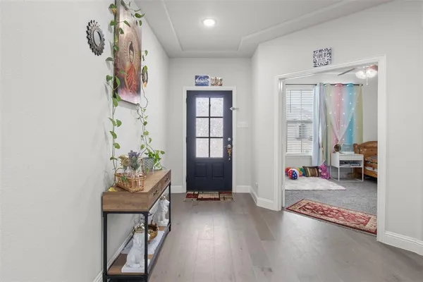 a view of an entryway with furniture and wooden floor