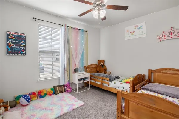 a bedroom with furniture and a window