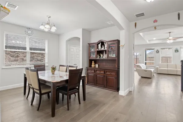 a view of a dining room with furniture and a chandelier